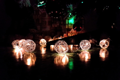 Christmas-tree-bauble-lights-lit-up-reflecting-on-a-table-surface