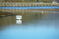 Fairbourne-estuary-with-calm-still-water-and-the-Fairbourne-railway-bridge-in-the-background