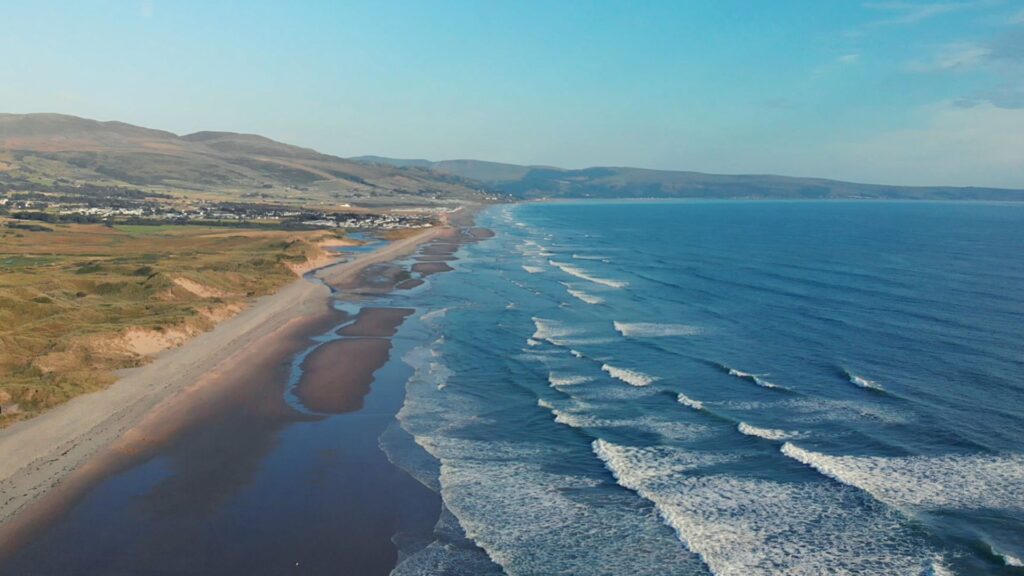 Aerial photo of Talybont beach and ocean waves near Barmouth in Wales